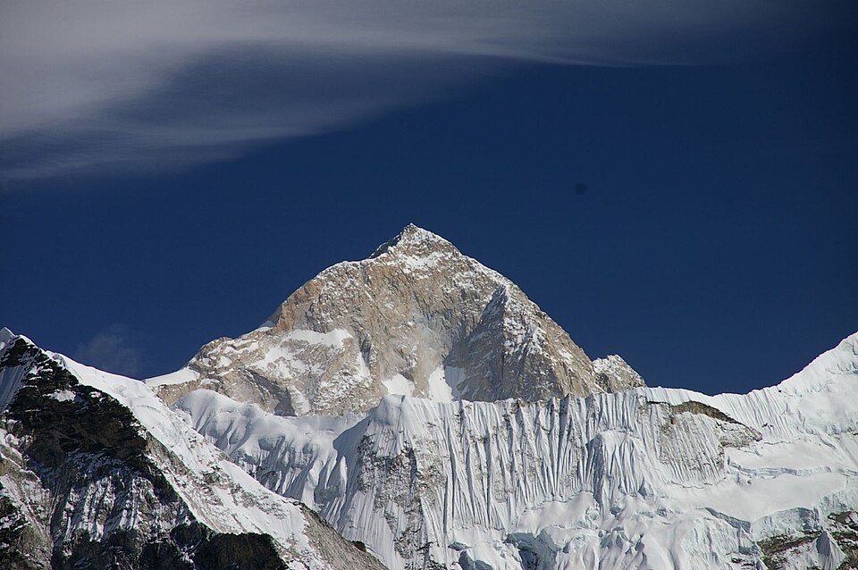 Snow-clad Makalu rising sharply against the sky.