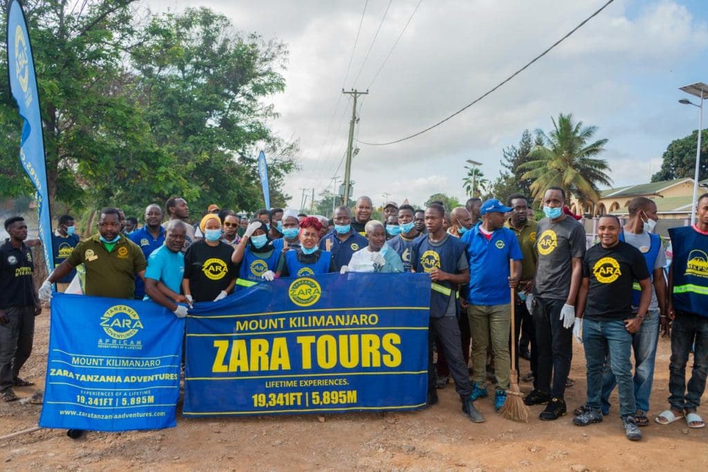 Zara Tanzania Adventures team and community members during a clean-up campaign in Moshi, promoting the “Green Tanzania Starts with Us” initiative.
