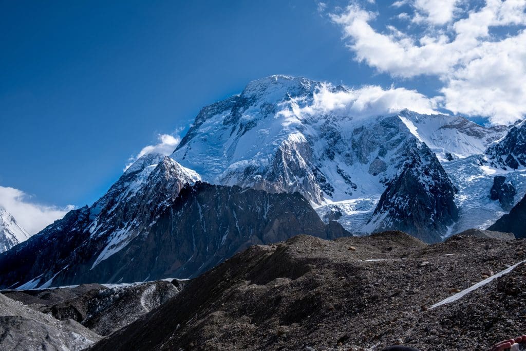 Broad Peak glistening with snow and ice against a clear horizon,