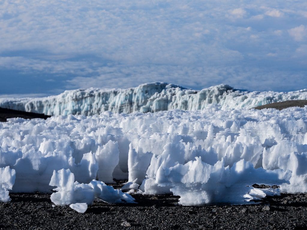 Close-up view of jagged ice formations and towering glaciers in the arctic summit zone of Mount Kilimanjaro.