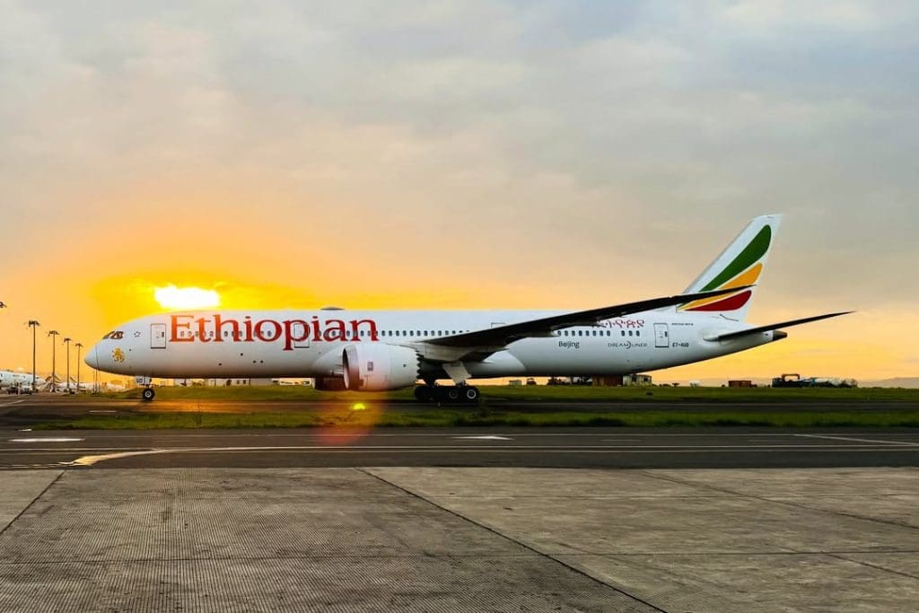 Ethiopian Airlines aircraft on the runway at sunset, representing international flights connecting travelers to Tanzania.