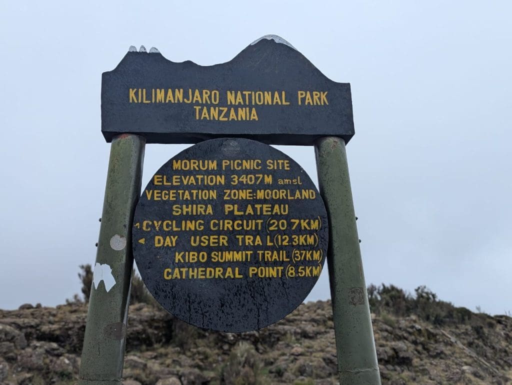 Morum Picnic Site sign on the Shira Plateau in Kilimanjaro National Park showing elevation and trail distances